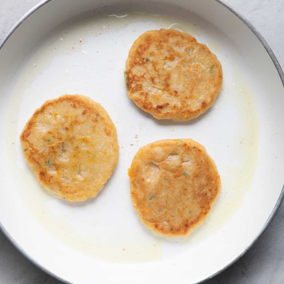 3 pancakes flipped showing golden color.