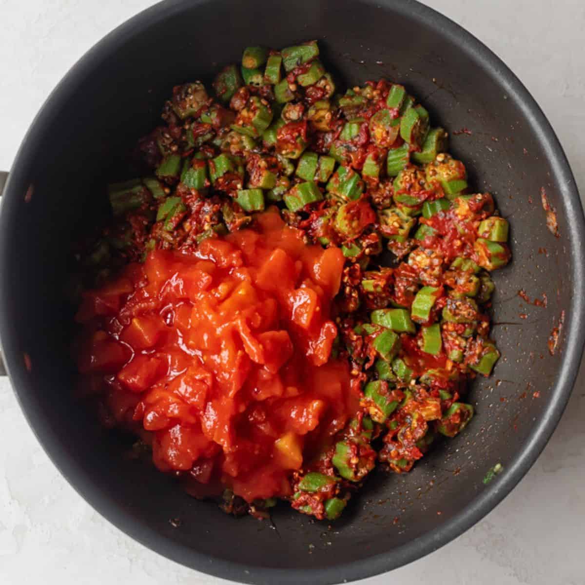 Diced tomatoes added to pot.