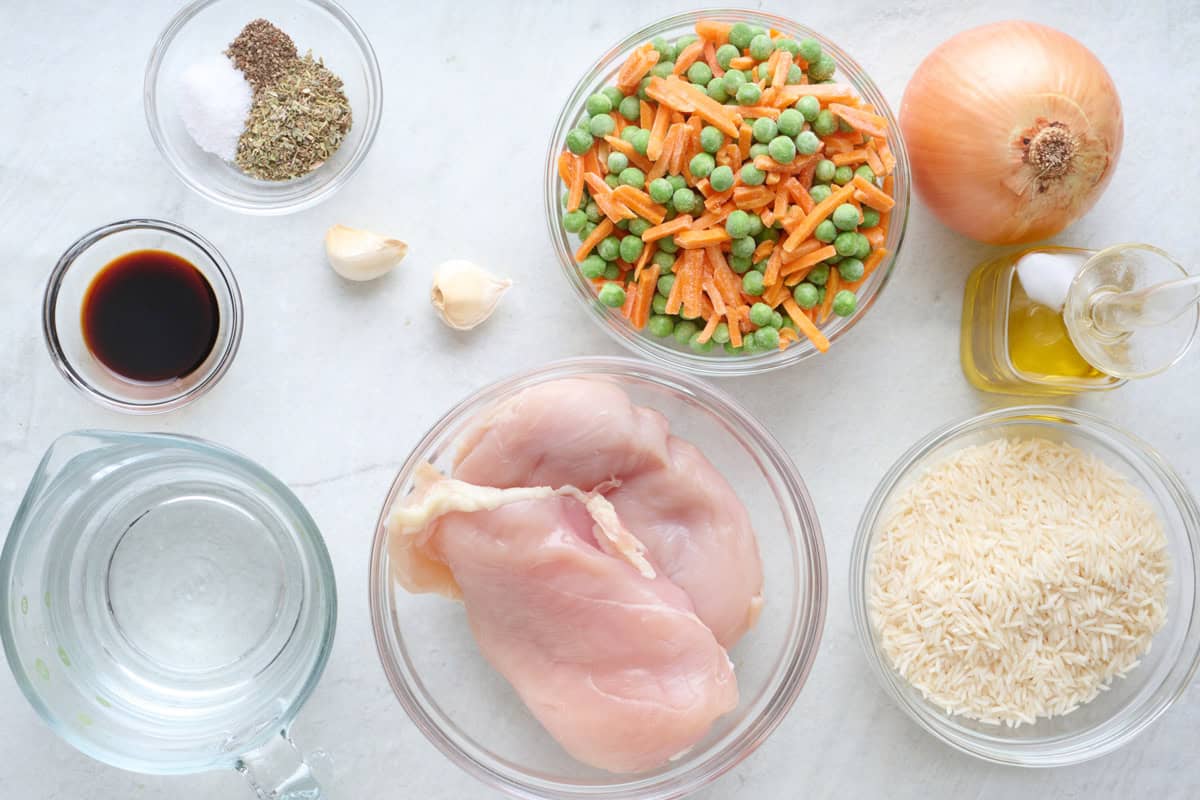 Ingredients for recipe: chicken, rice, frozen peas and carrots, onion, oil, garlic, soy sauce, and spices.