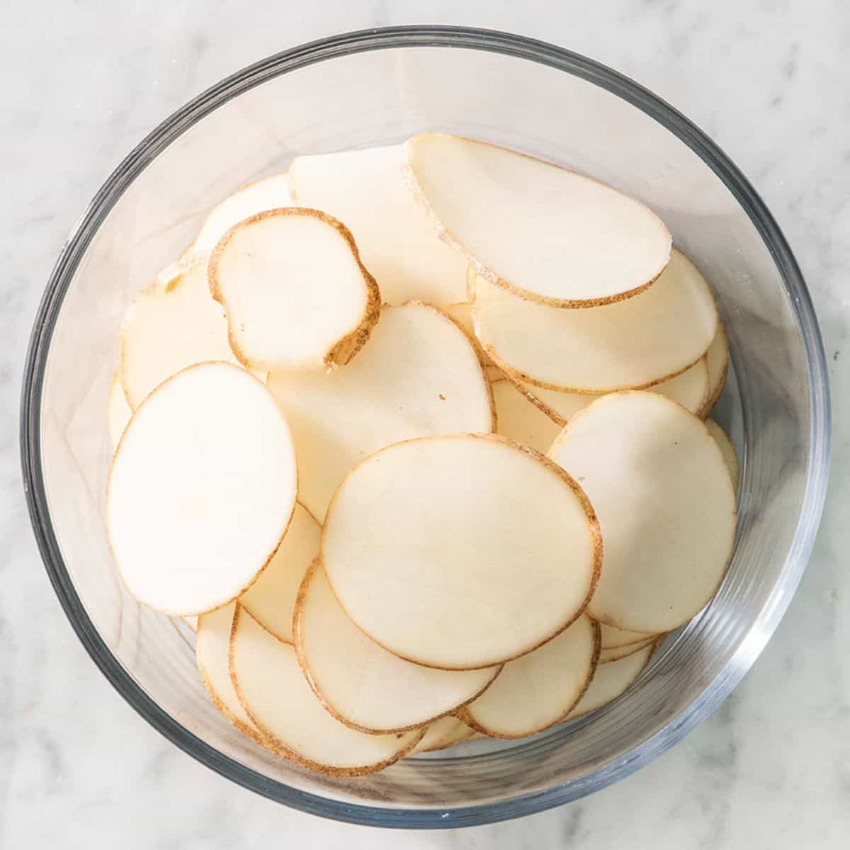 Sliced potatoes in a bowl.