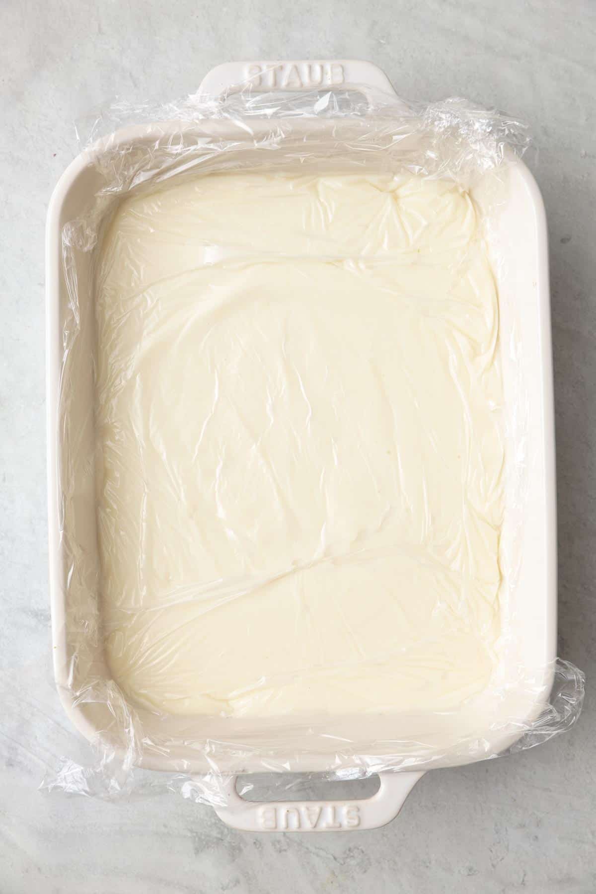 Plastic wrap over the semolina pudding pressed down tightly.