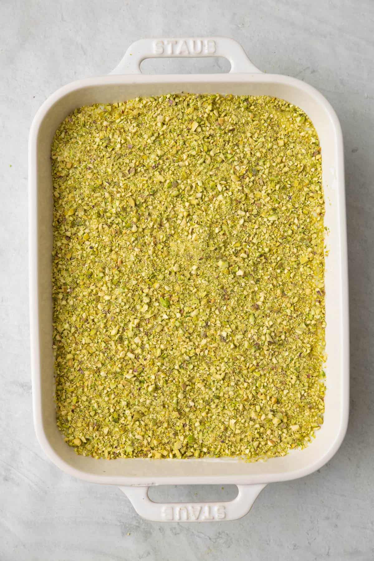 Crushed pistachios on top of the semolina pudding.