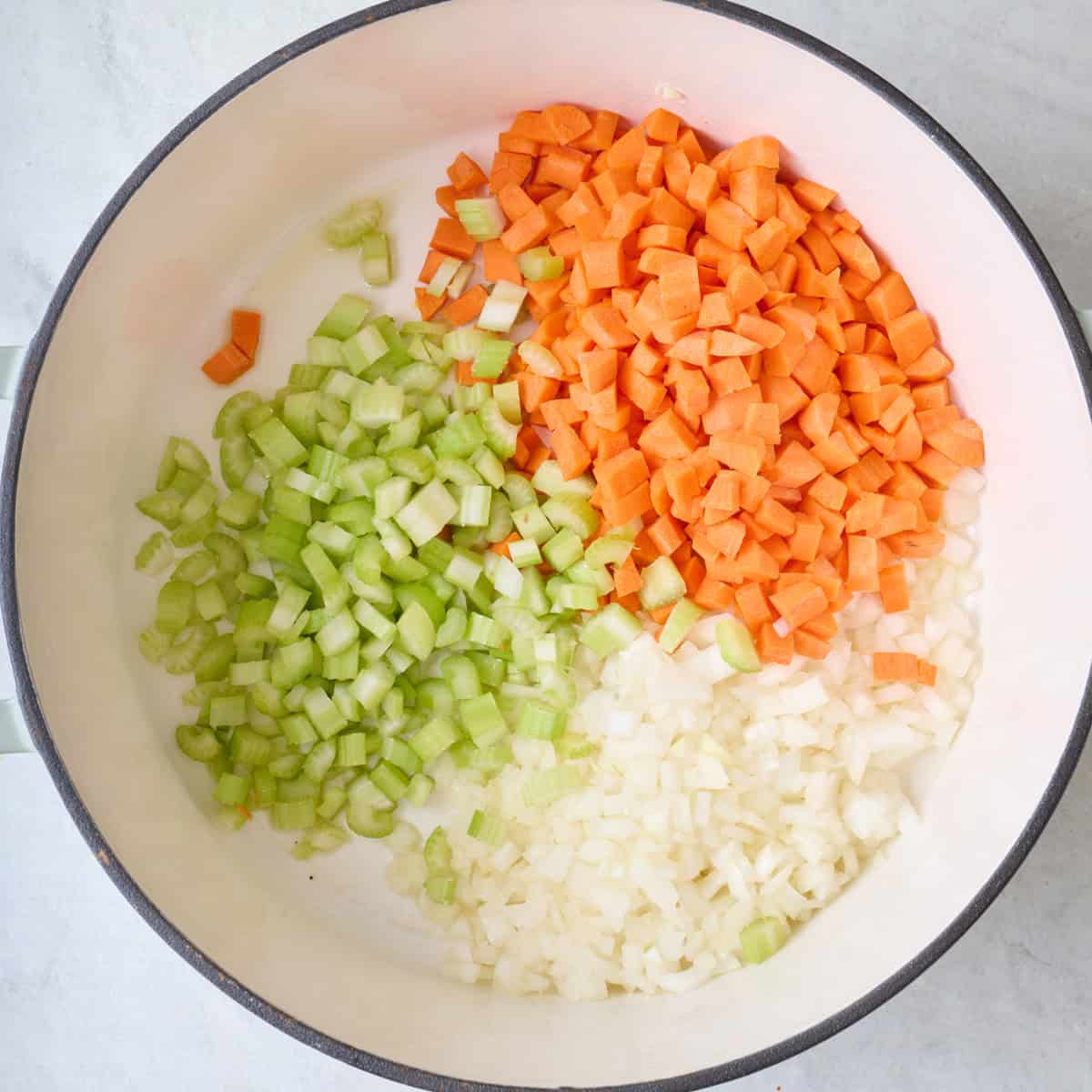 Chopped veggies in pot before cooking.