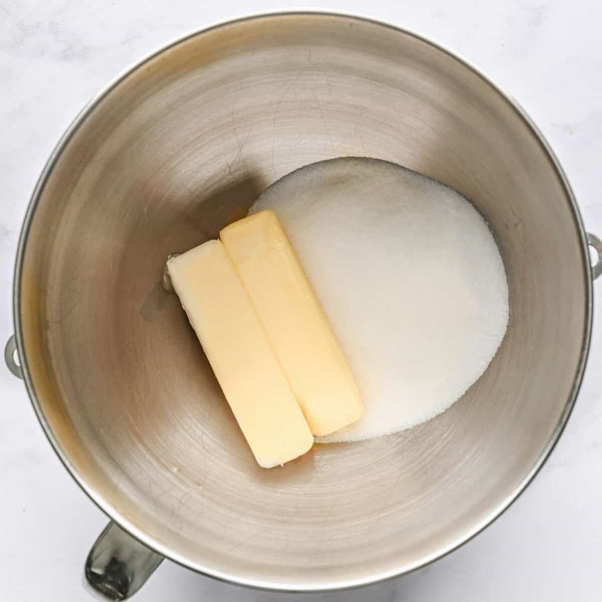 Softened butter and sugar in the bowl of a stand mixer.