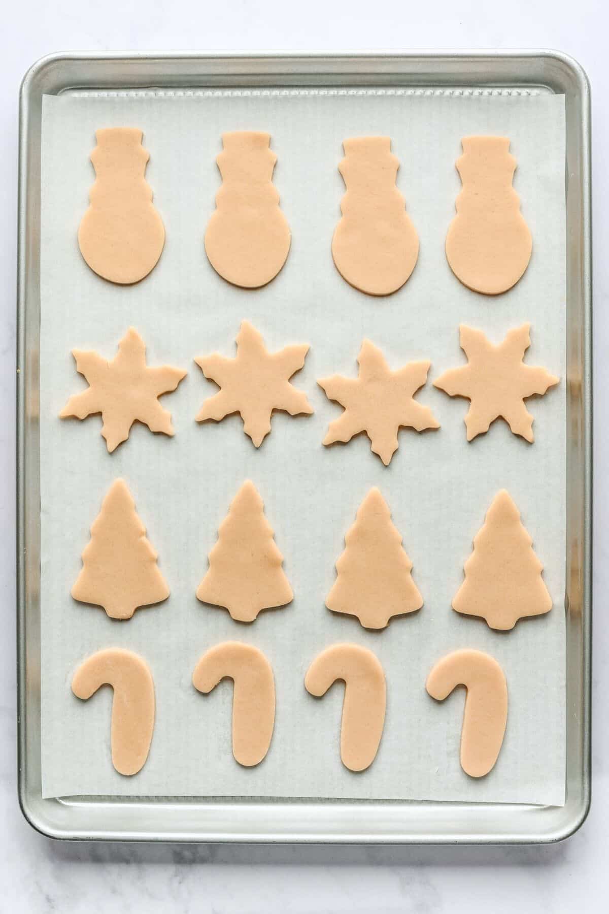 Cut out cookies on a sheet pan before baking.