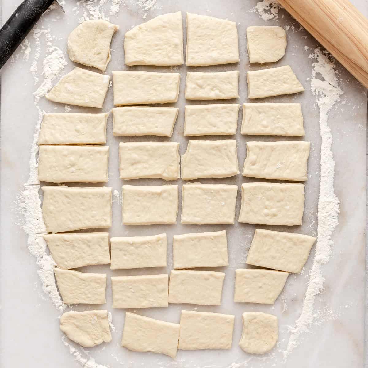 Pizza dough rolls out flat and cut into equal pieces.