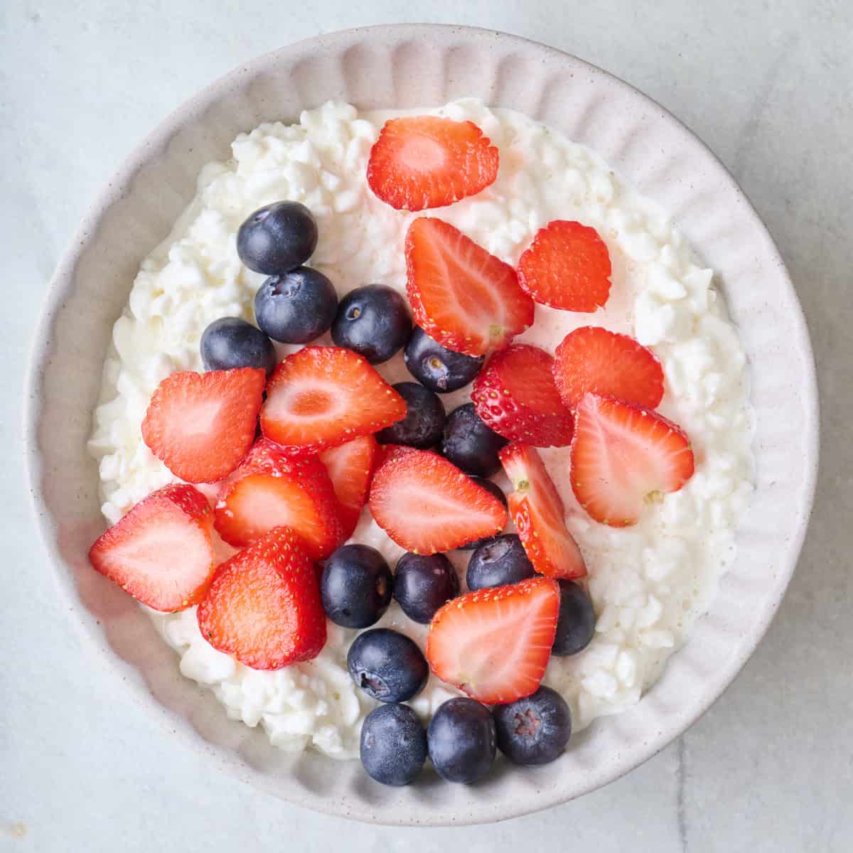 Fresh fruit added on top of cottage cheese.