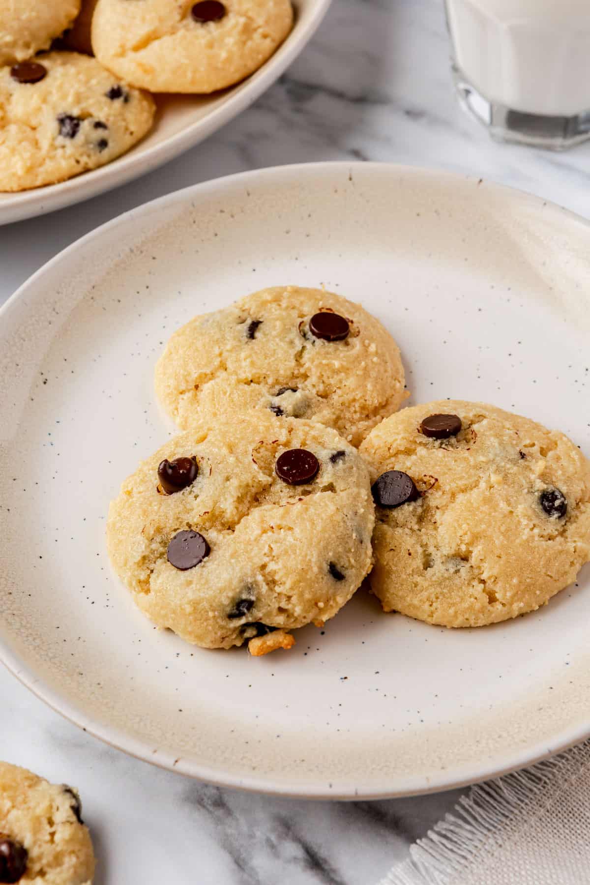 Three cottage cheese chocolate chip cookies on a small plate.