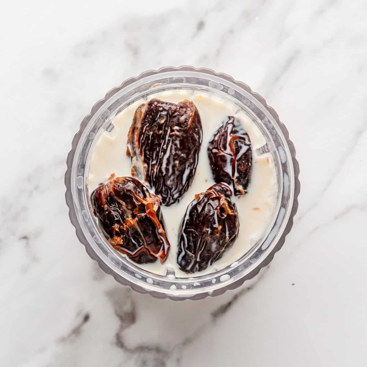 Dates, milk and baking soda in a blender before soaking.