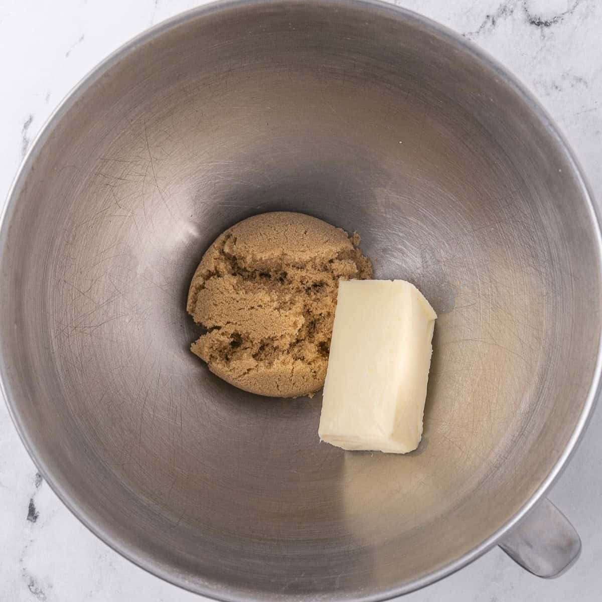 Butter and brown sugar in the bowl of a stand mixer before mixing.