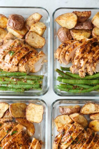 Honey mustard chicken with roasted potatoes and green beans in meal prep containers.