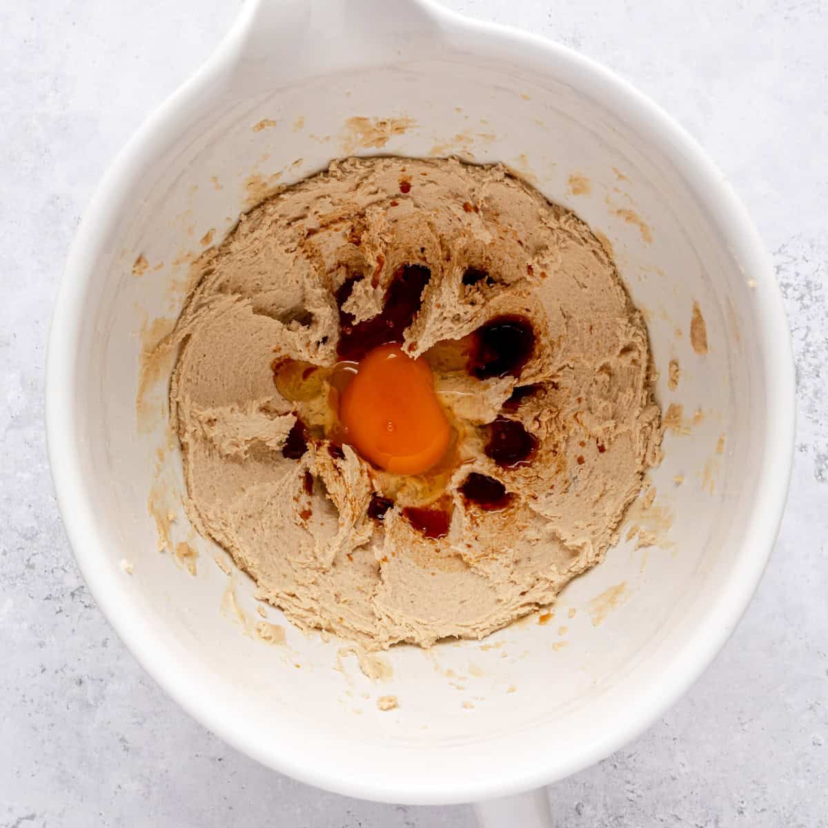 Creamed butter and sugar in the bowl of a stand mixer with egg and vanilla added.