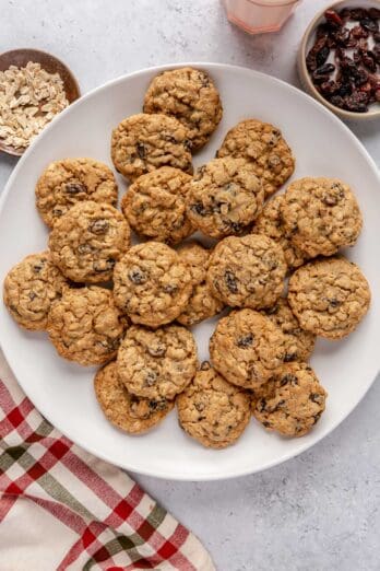 Cookies on a round plate with dishes nearby.