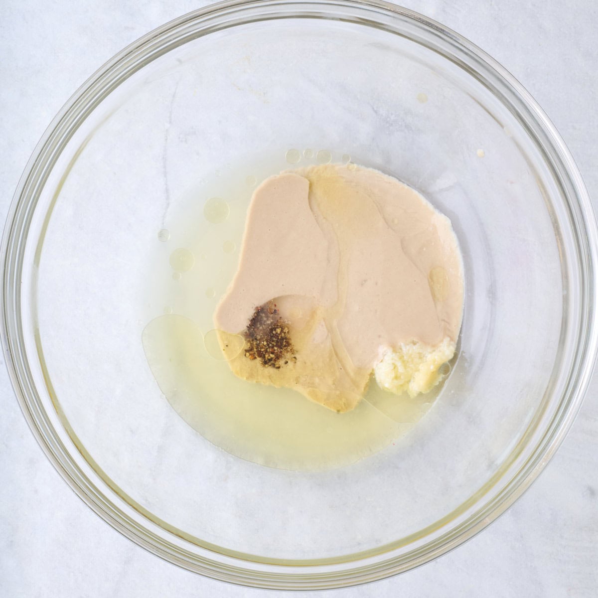 Tahini dressing ingredients in a bowl before mixing.