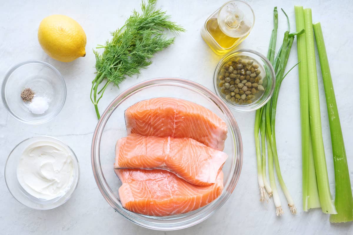 Ingredients for recipe: lemon, seasoning, yogurt, fresh dill, salmon fillets, oil, capers, green onions and celery.