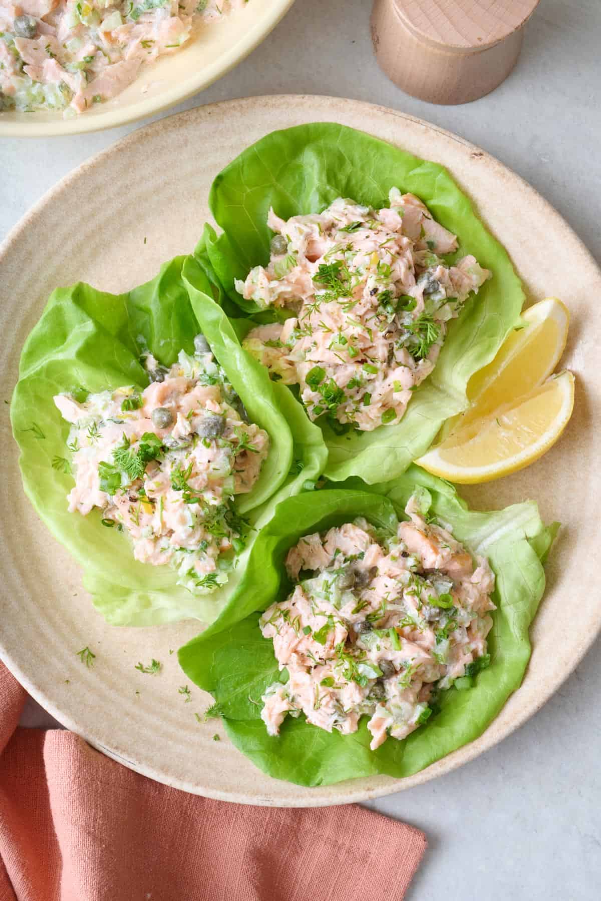 Three lettuce cups filled with homemade salad salad.