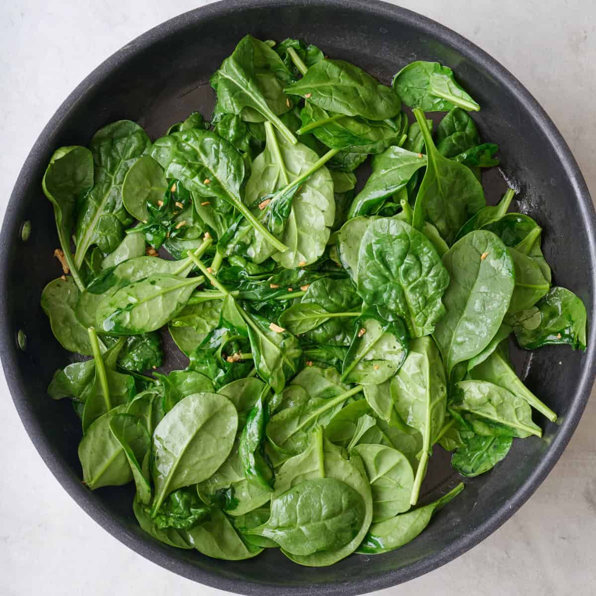 Spinach added and lightly before tossing in the garlic and oil.