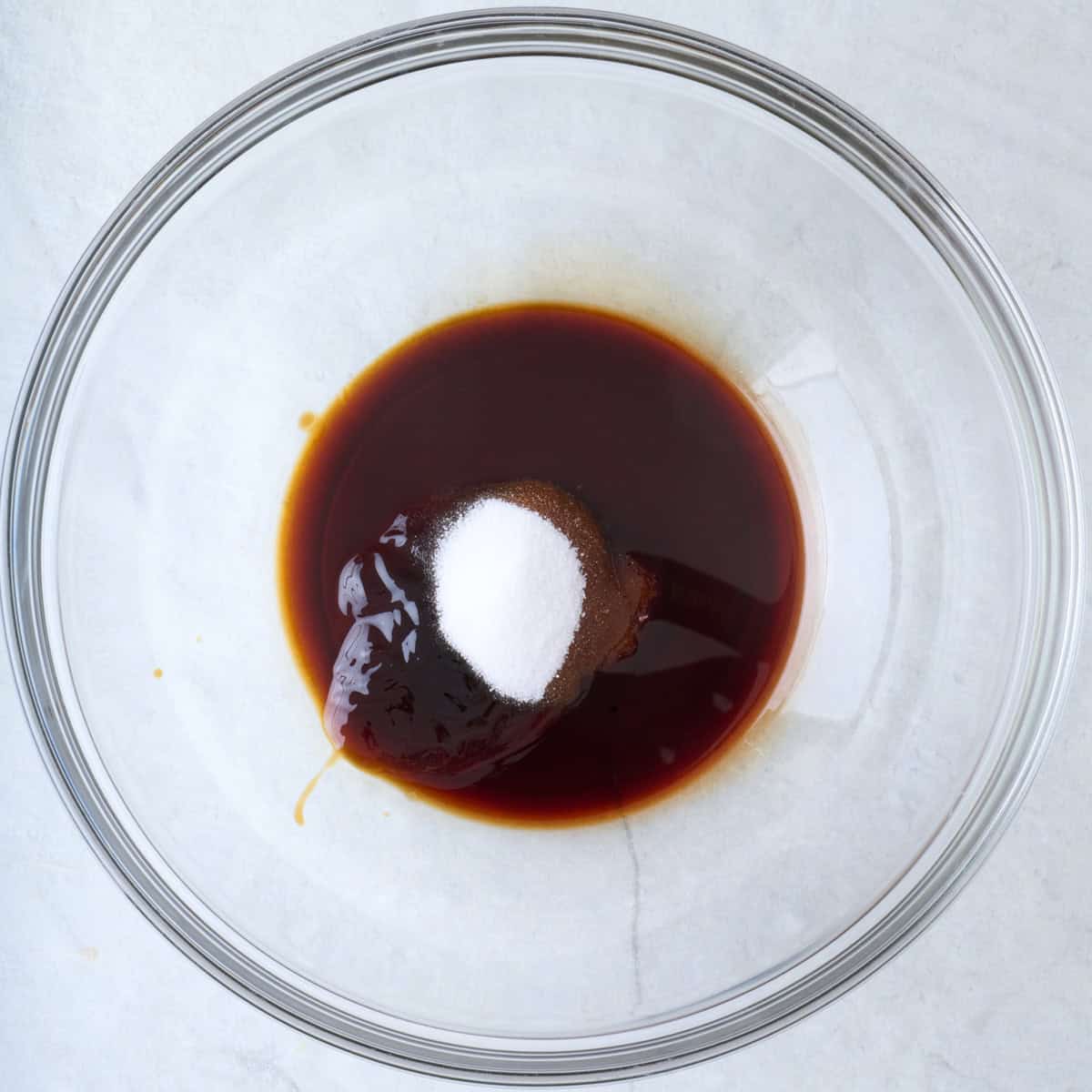 Oyster sauce, soy sauce and sugar in a bowl.