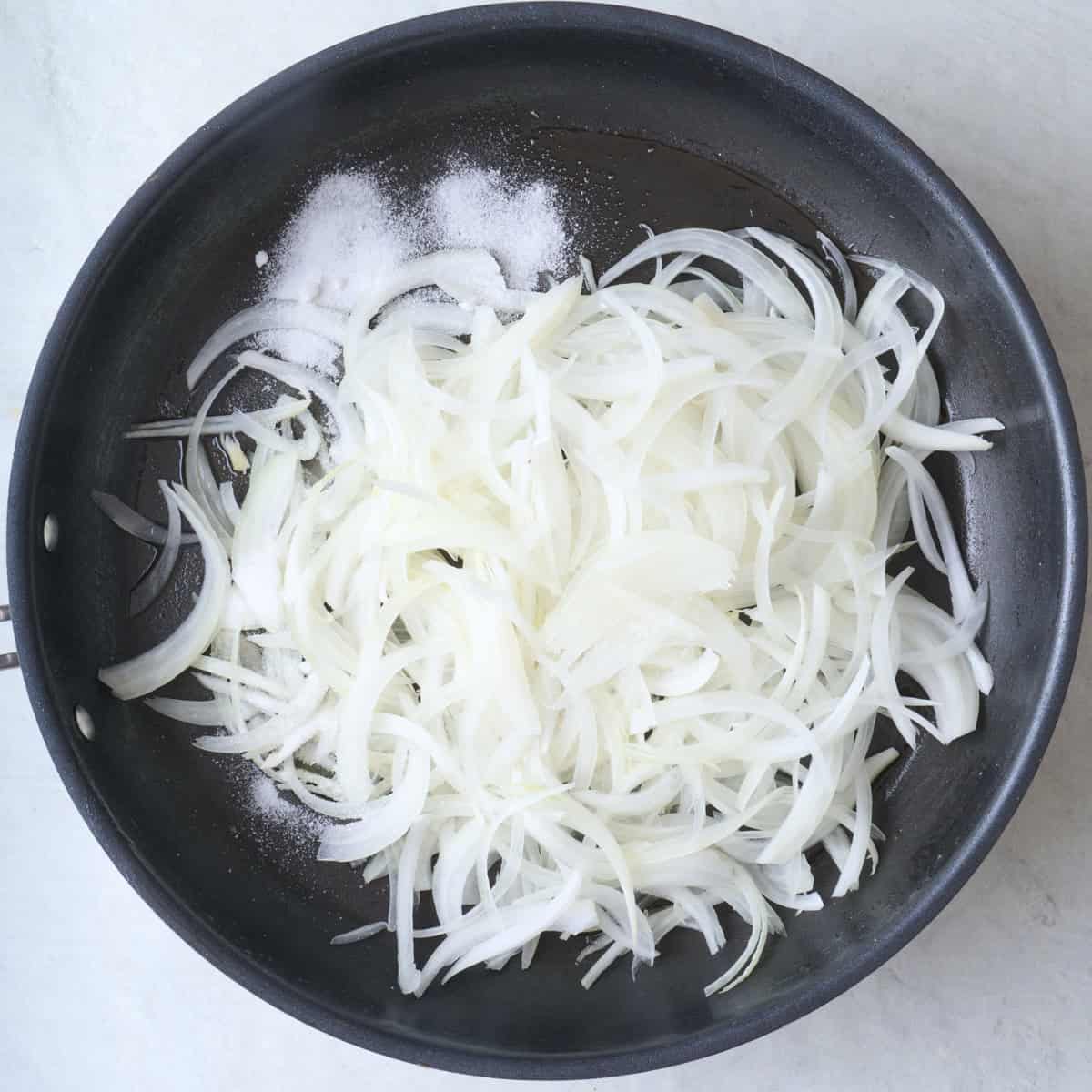 Onions salt and sugar in oiled skillet.