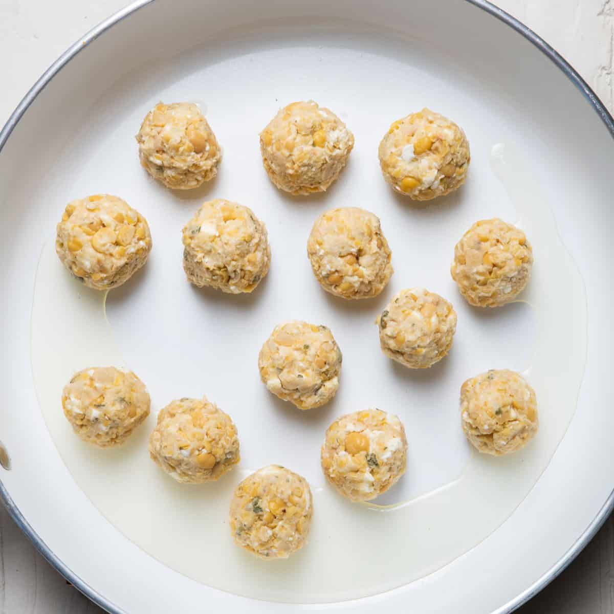 Mixture formed into small balls and placed in an oiled skillet.