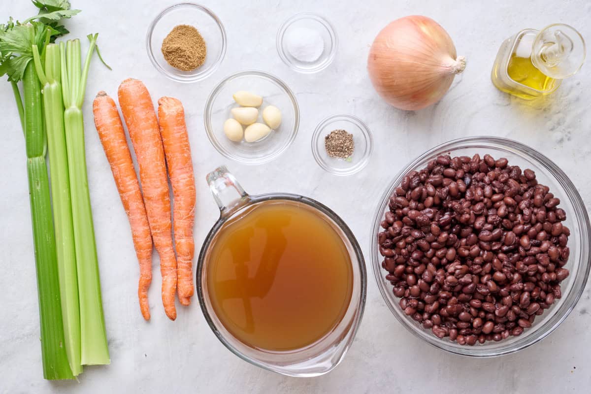 Ingredients for recipe: celery, carrots, cumin, garlic, salt, pepper, vegetable broth, onion, and oil.