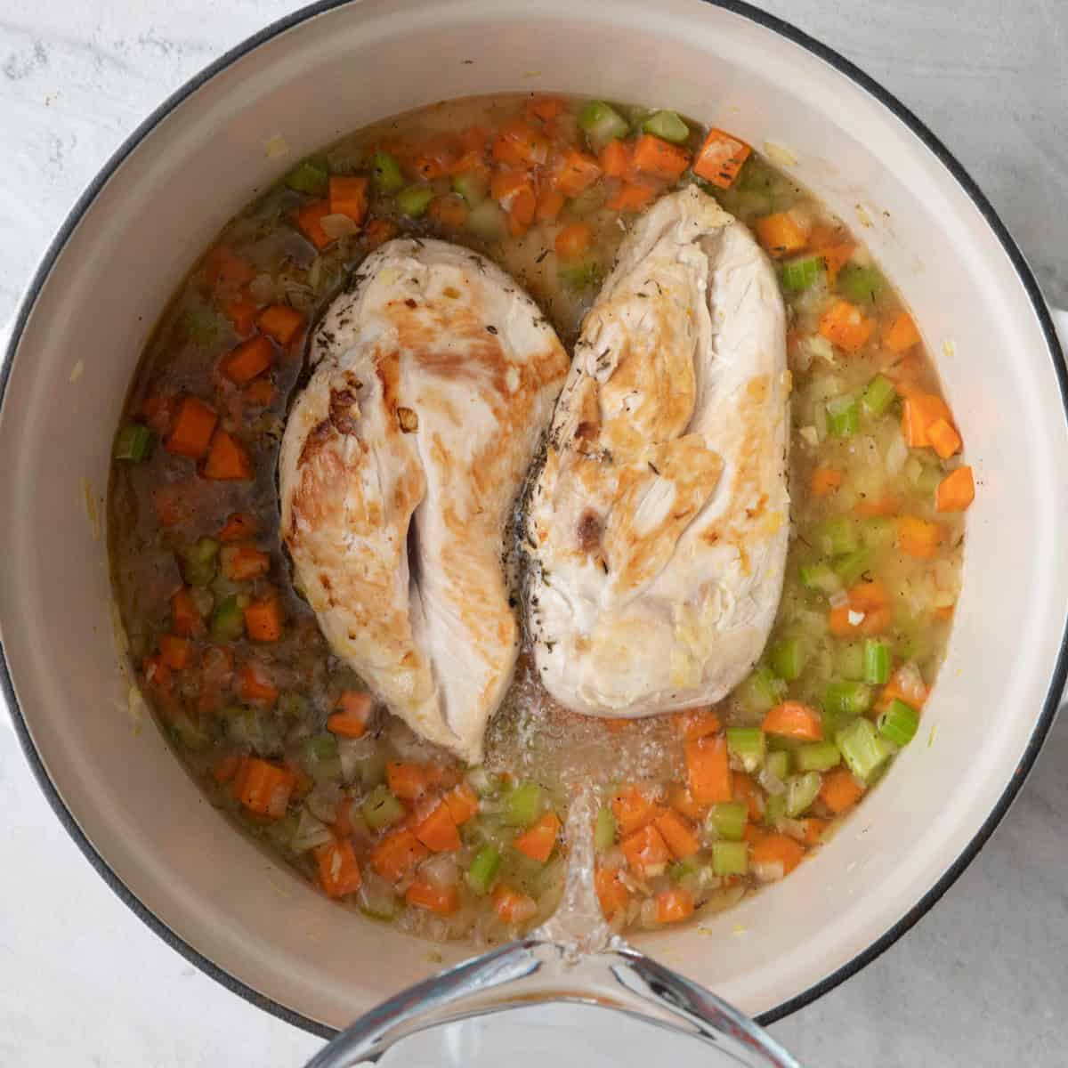 Adding water to pot after flipping chicken.