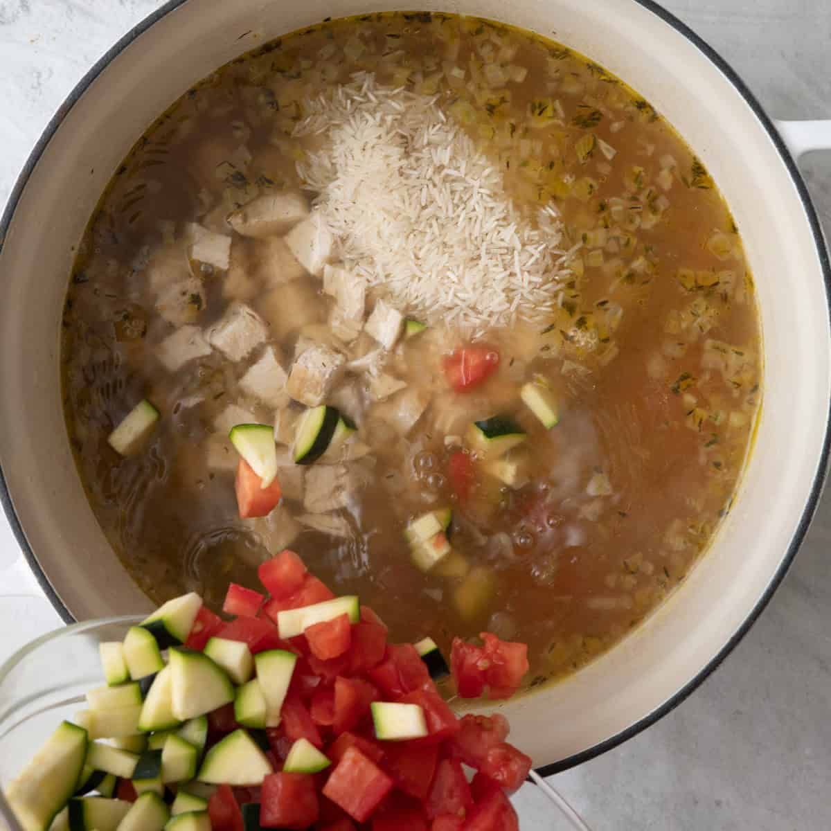 Cubed chicken added back to soup along with the rice, tomatoes and zucchini.