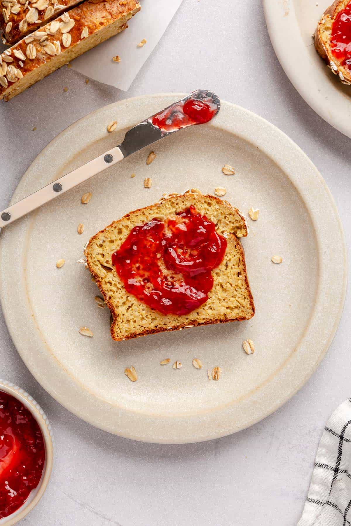 Cottage cheese bread slice on a plate topped with jam.