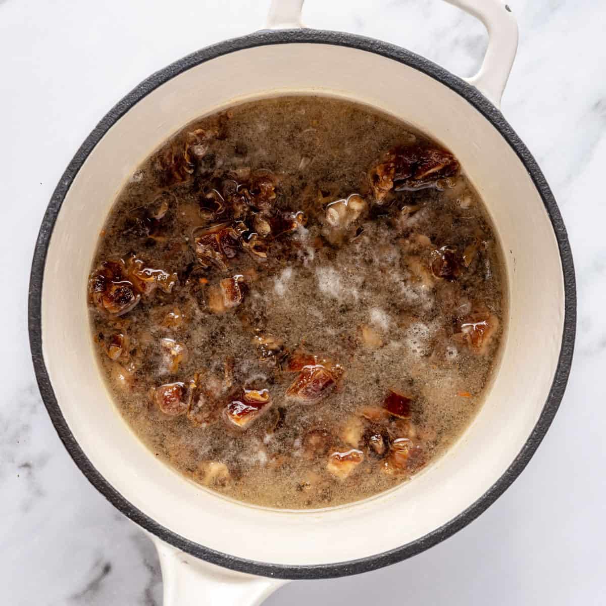 Chopped dates in pot of hot water.