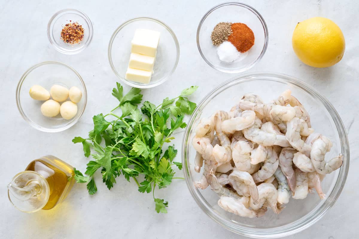 Ingredients for recipe: red pepper flakes, garlic, oil, parsley, butter, seasonings, shrimp, and lemon.