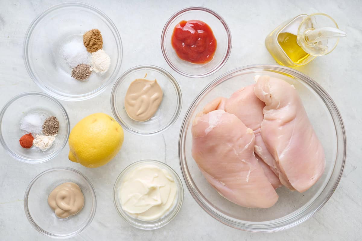 Ingredients for recipe: oil, Dijon mustard, lemon, garlic powder, cumin, salt, pepper, and chicken breasts. Plus ingredients for the sauce: mayo, ketchup, Dijon, smoked paprika, garlic powder, salt and pepper.