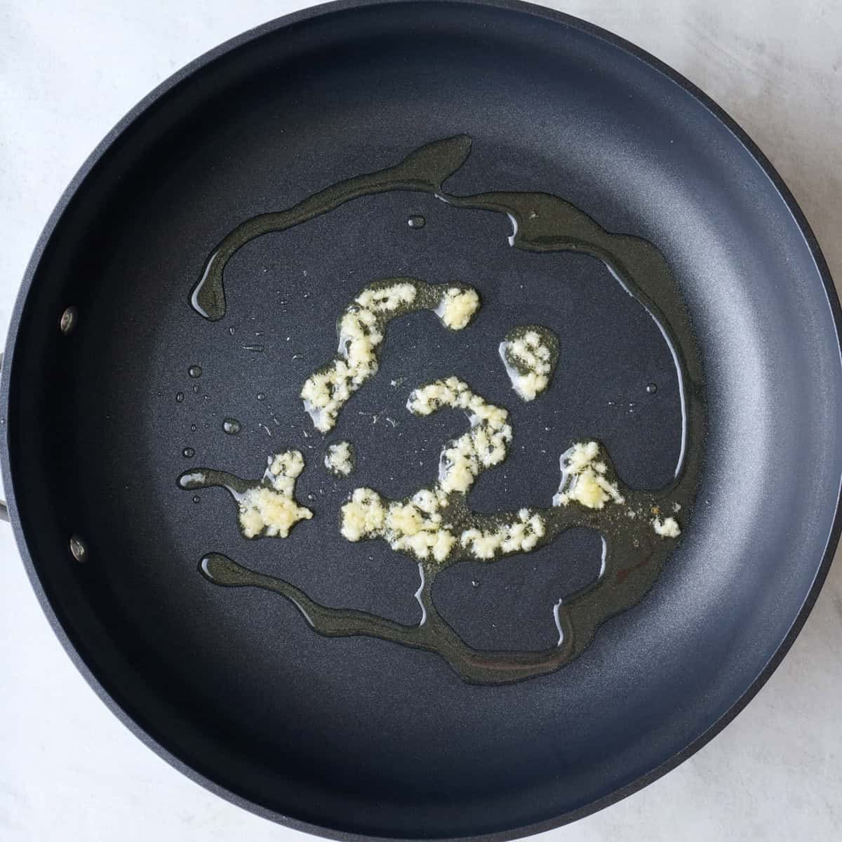 Garlic and oil in a pan.