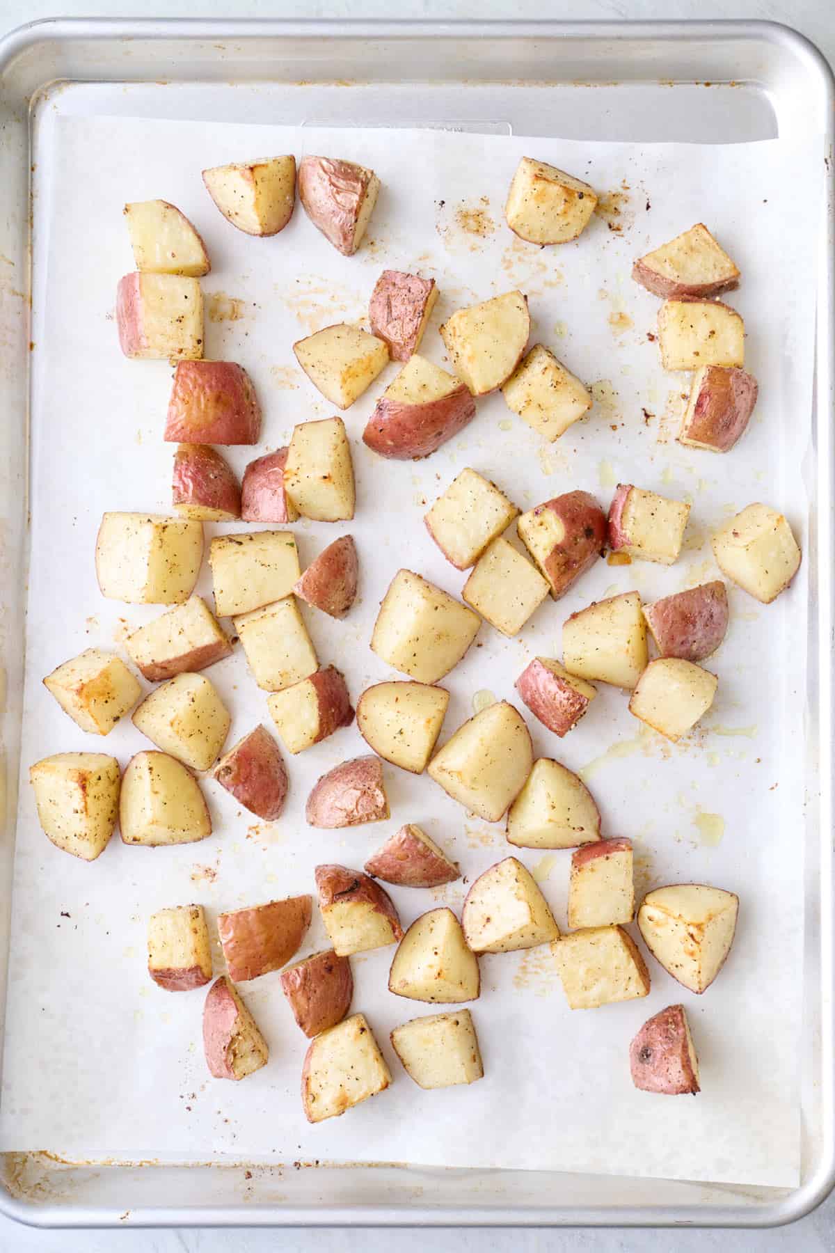 Seasoned red skin potatoes cut into cubes after cooking.