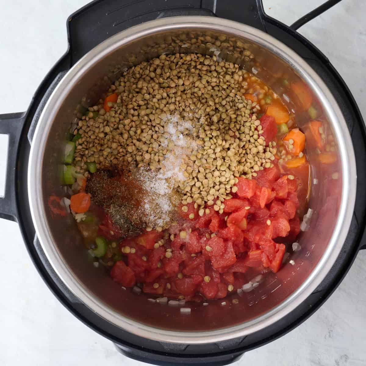 Lentils, tomatoes, and seasonings added too cooked aromatics.