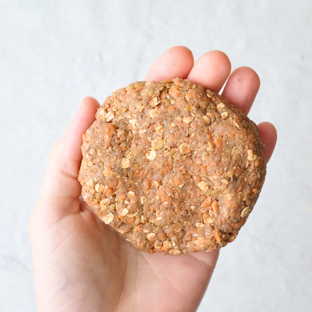 Lentil mixture formed into a burger patty.