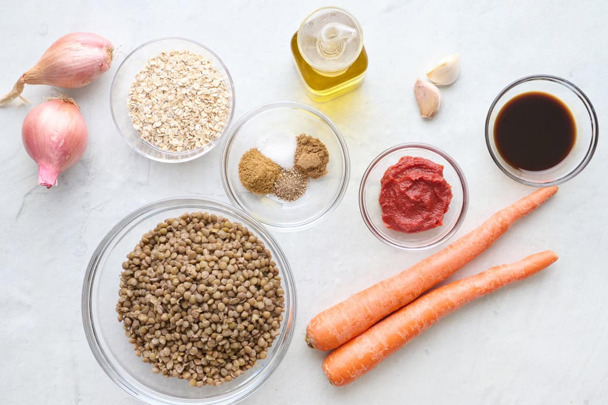 Ingredients for recipe: shallots, oats, lentils, spices, tomato paste, oil, garlic, carrots and sauce.