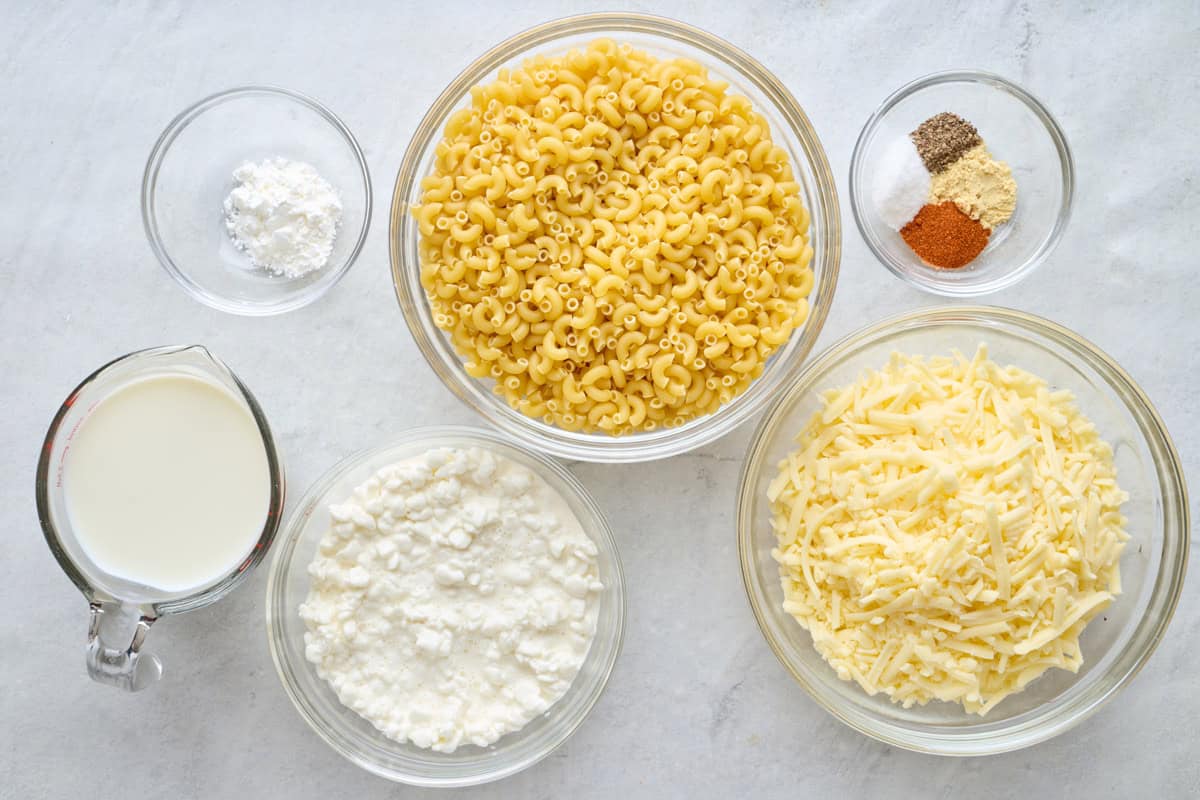 Ingredients for recipe: cornstarch, milk, uncooked macaroni noodles, cottage cheese, seasonings, and white cheddar cheese.