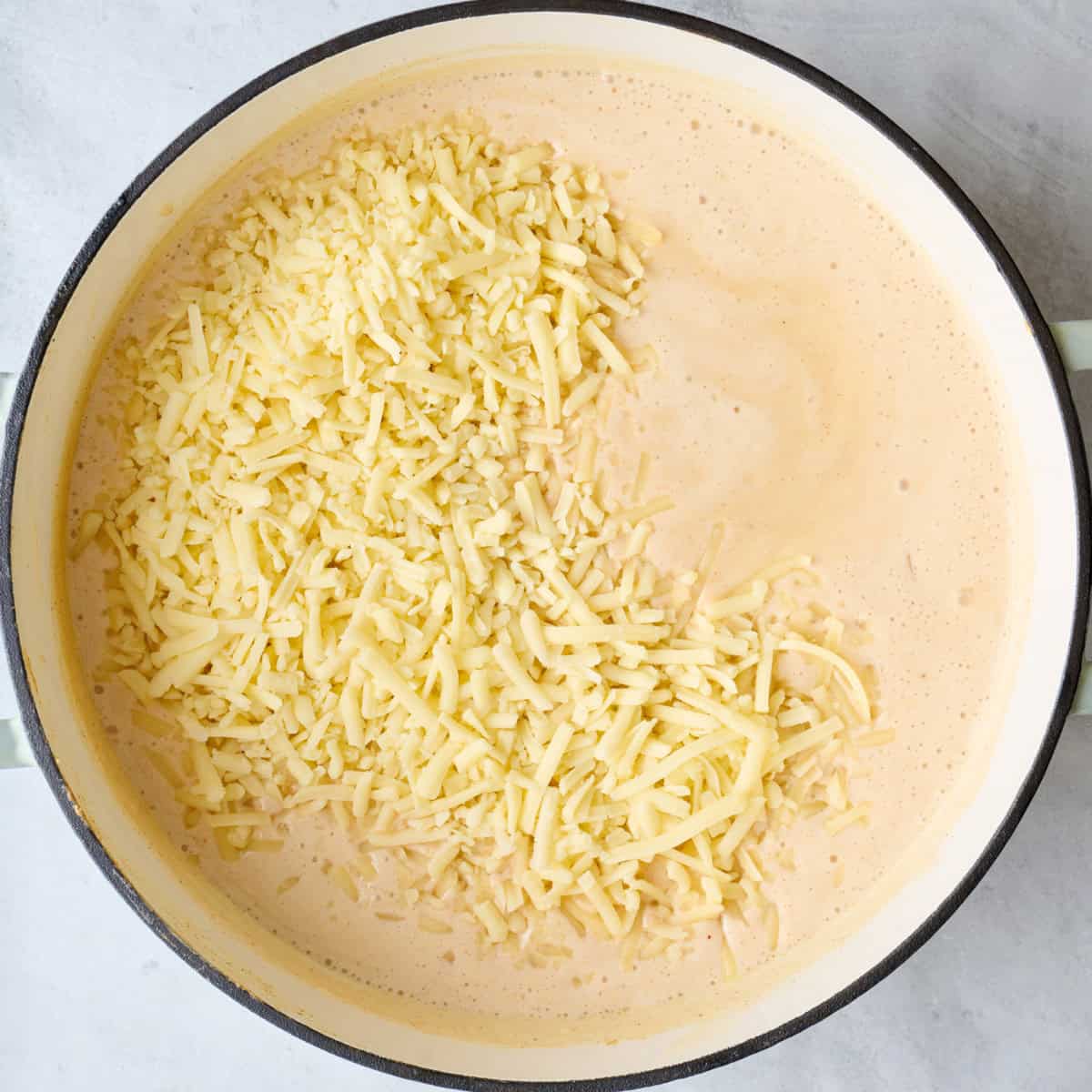 Shredded cheese added to sauce.