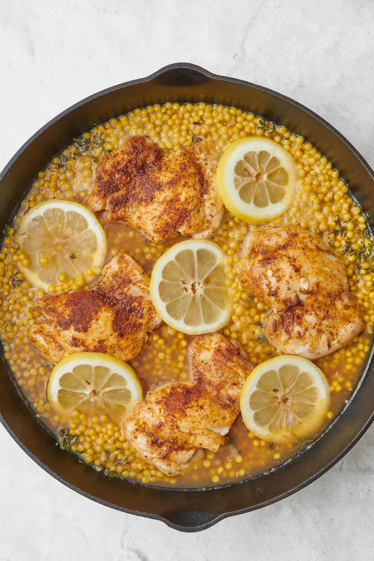 Seasoned chicken added to pan before baking.