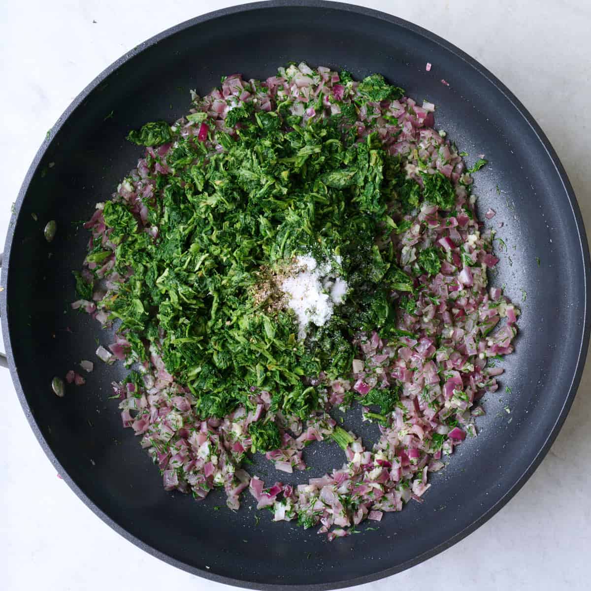 After cooking onions with spinach, salt and pepper added.