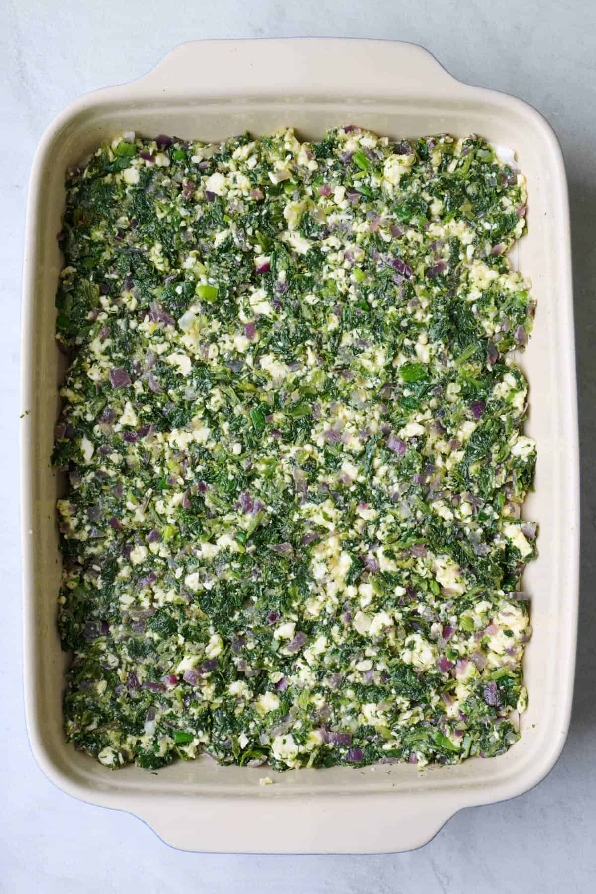 Even layer of spinach mixture added.