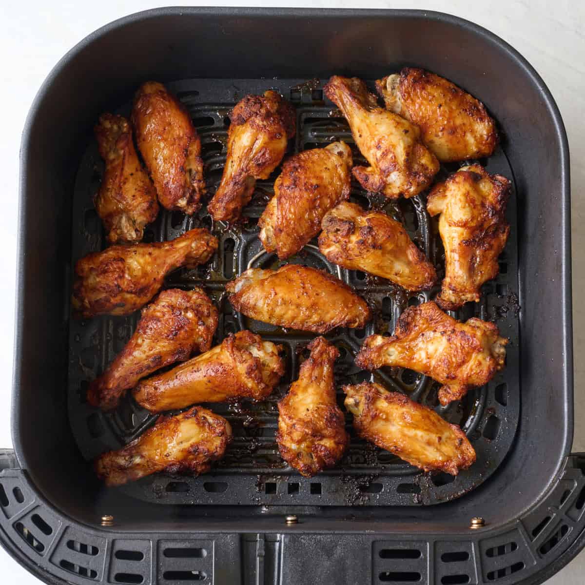 Air fried chicken wings in basket.