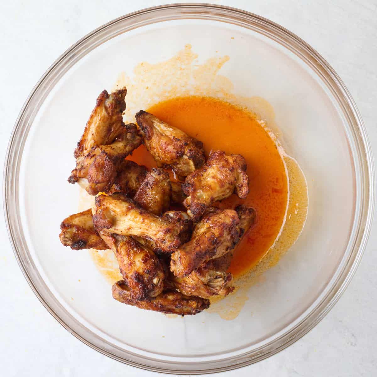 Air fried chicken wings added to buffalo sauce.