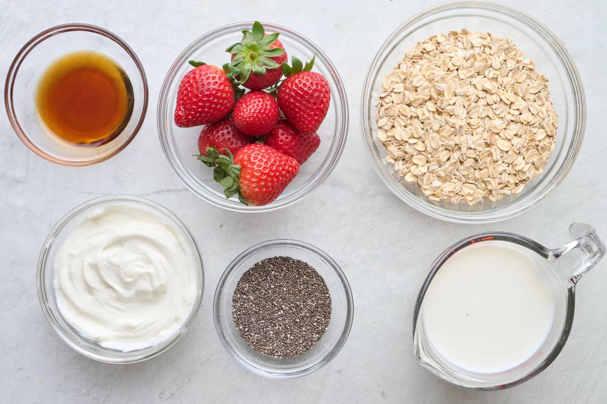 Ingredients for recipe: maple syrup, Greek yogurt, chia seeds, strawberries, oats, and milk.