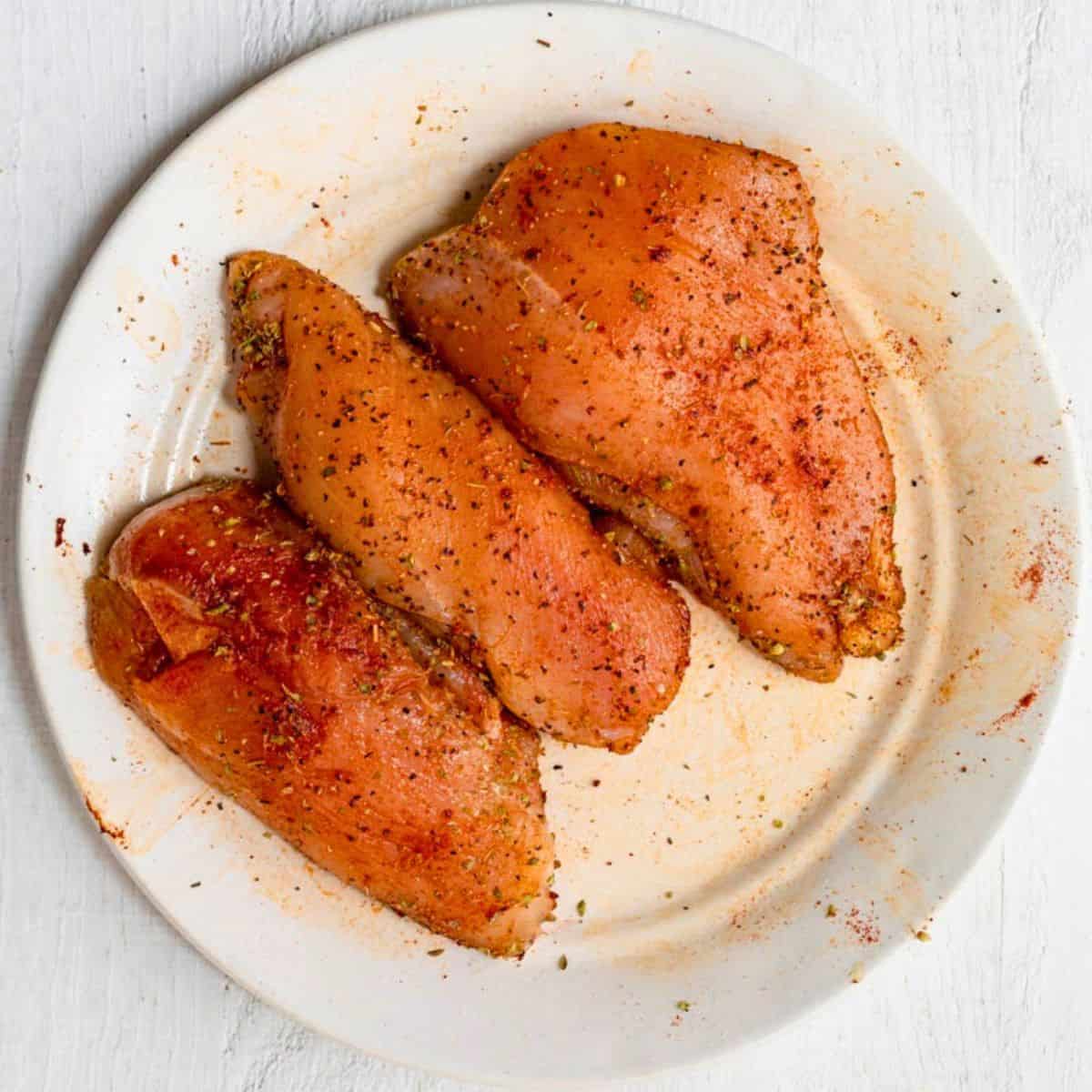 Sliced chicken after coating in seasoning.