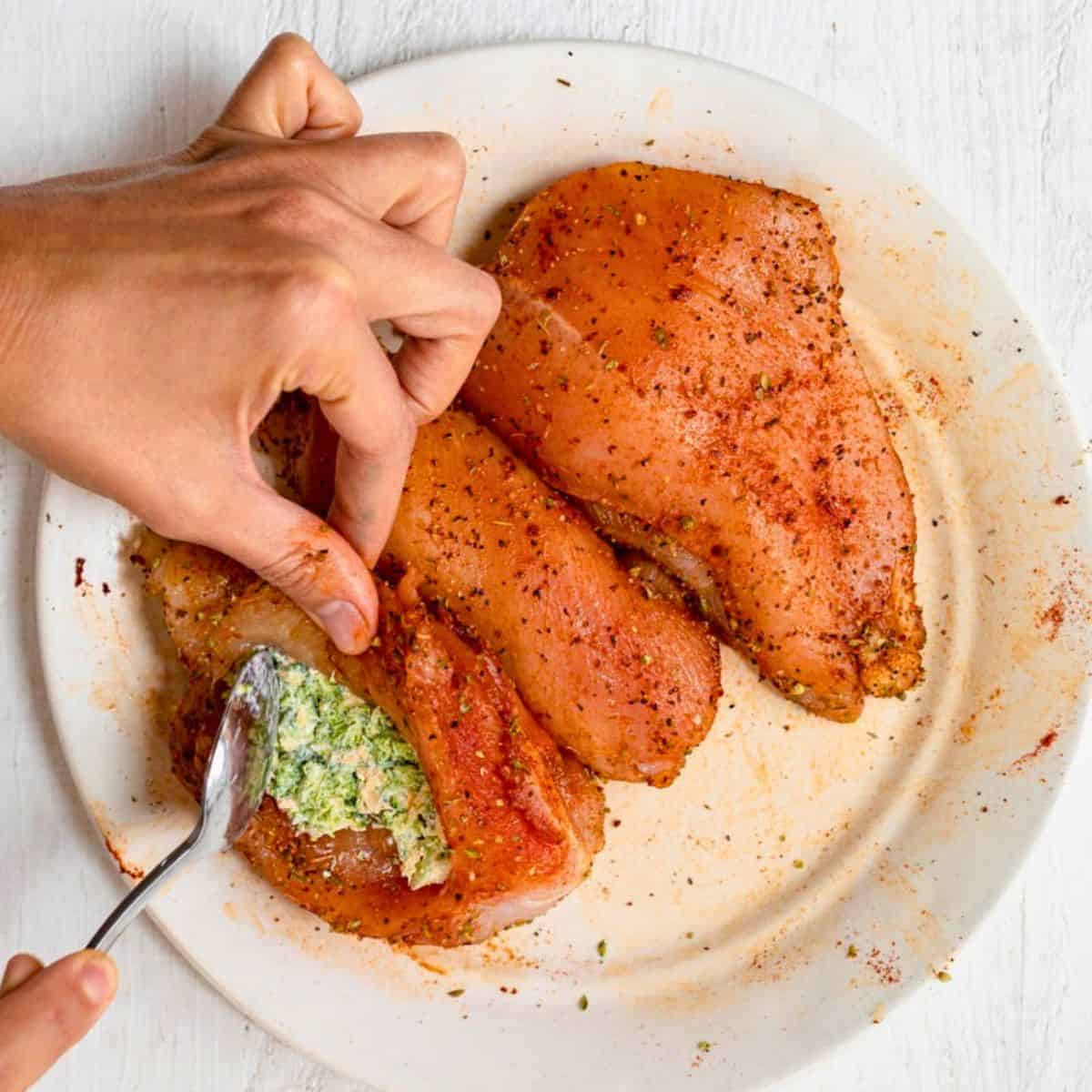 Filling chicken pock with broccoli cheese mixture.