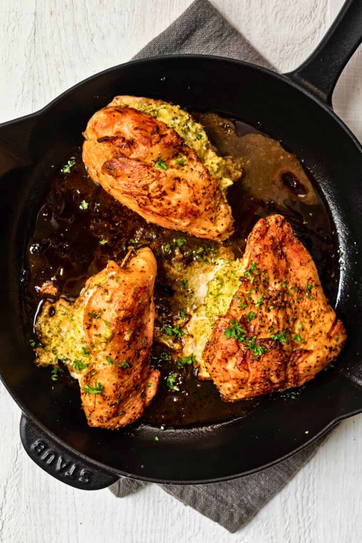 Broccoli cheese stuffed chicken breasts in a skillet.