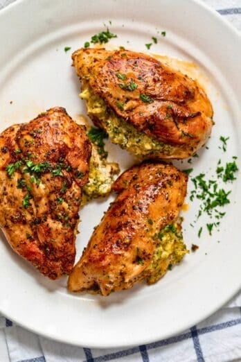 Stuffed chicken breasts on a plate.