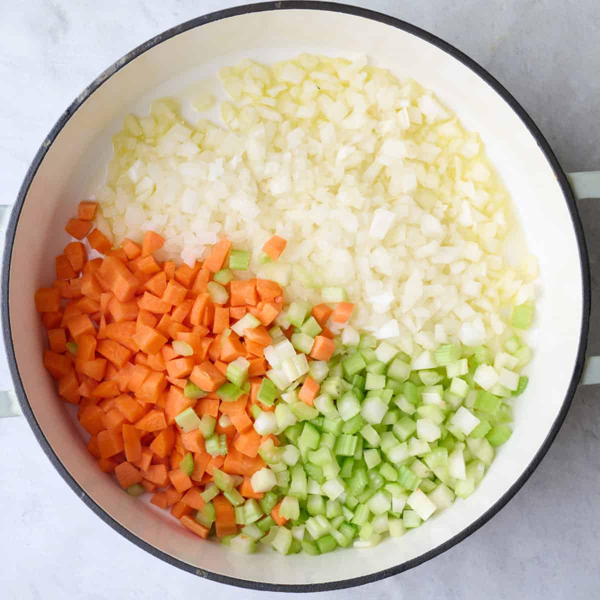 Onions, carrots, celery, salt and pepper in a pot.