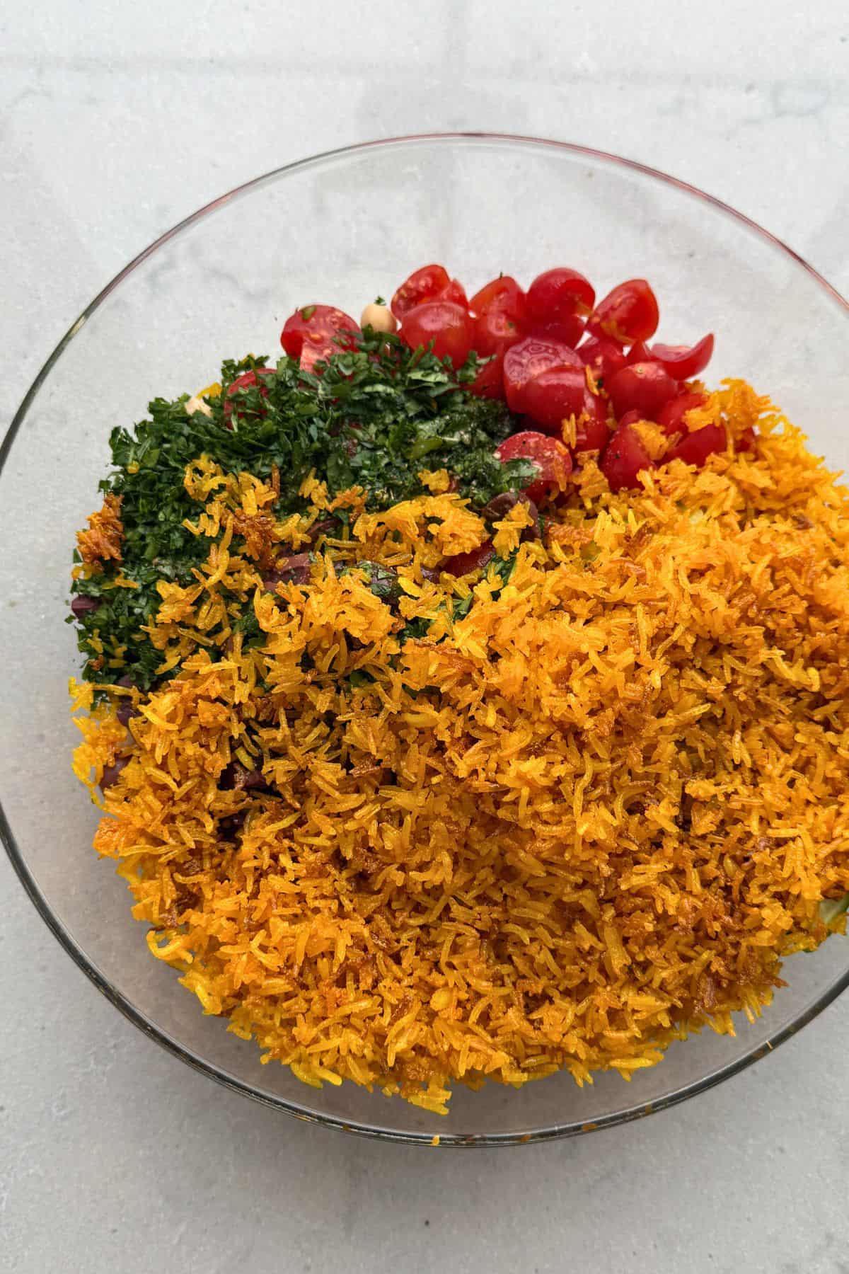 Crispy rice salad ingredients in a bowl before tossing together.